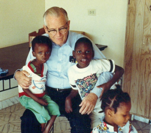 Fr. William Wasson with children at St. Damien Hospital